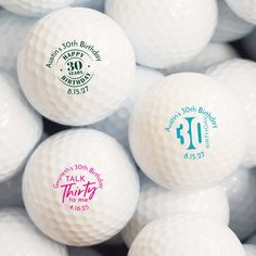 several white golf balls with 30th birthday designs on them