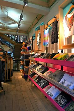 the inside of a clothing store filled with lots of items