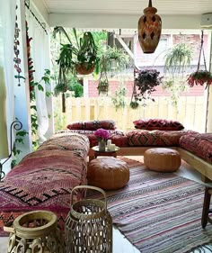 a living room filled with lots of furniture and plants