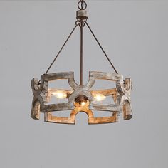 a wooden chandelier with three lights hanging from it