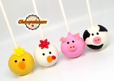 four cake pops with farm animals on them