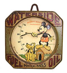 an old fashioned clock with mickey mouse on it's face and thermometer