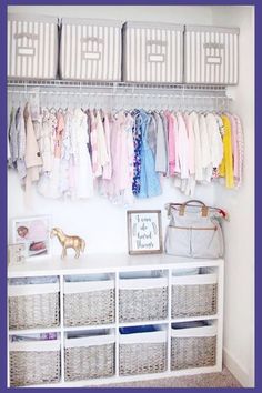 an organized closet with baskets and clothes hanging on the wall, along with baby's clothing