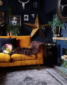 a living room filled with lots of furniture and pictures on the wall next to a fire place