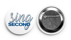 a button with the word sing second printed on it, next to a pin that says sing second