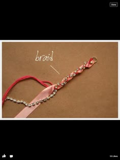 a pink ribbon and some beads on a brown surface with the word braid written in white