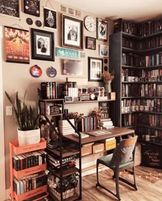 a room with many bookshelves and pictures on the wall