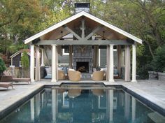 an outdoor living area next to a swimming pool