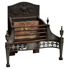 an old fashioned metal bed with wooden slats and carvings on the headboard, sitting against a white background