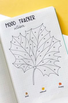 a notebook with a leaf drawn on it and the words mood tracker next to it