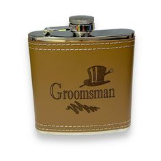 a brown flask with the name groomman on it and an image of a hat