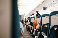 people are sitting on the seats in an airplane