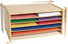 a stack of folded papers in a wooden drawer