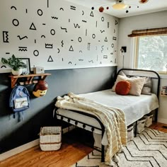 a bedroom with black and white wallpaper on the walls