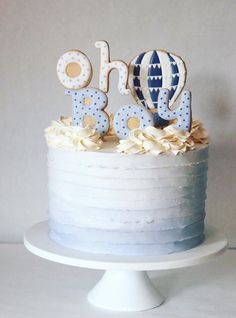 a blue and white cake with the word oh boy on top