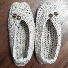 pair of crocheted slippers sitting on top of a wooden floor