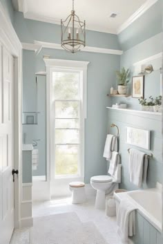 a bathroom with blue walls and white fixtures