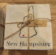 the new hampshire coaster is wrapped in twine and has a tag that says enjoy