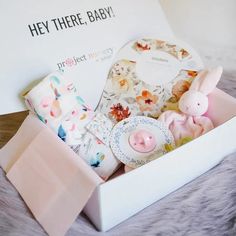 a baby shower gift set in a white box with pink and blue decorations on it