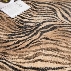 a close up of a rug with a book on it