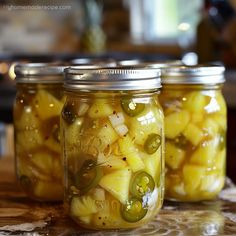 three mason jars filled with pickles and onions