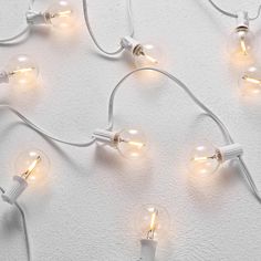 several light bulbs are connected to each other on a white surface with no one around them