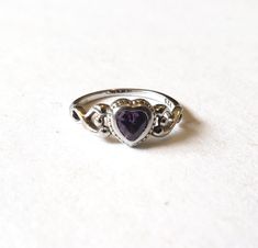 Delicate sterling silver amethyst ring. The pinky-purple stone is heart-shaped and the motif carries over to the sides of the ring. Marked 925 Size: US 2 1/2 Condition: Excellent. This piece is in like new condition. Rings Purple, Nail Jewelry, Classy Jewelry, Fantasy Jewelry