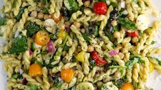 pasta salad with tomatoes, broccoli and chickpeas on a white plate