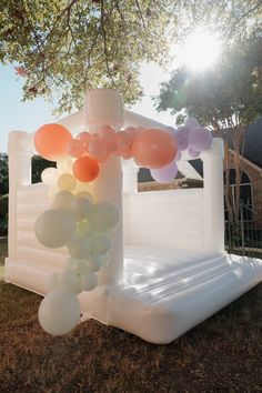 an inflatable arch with balloons attached to it