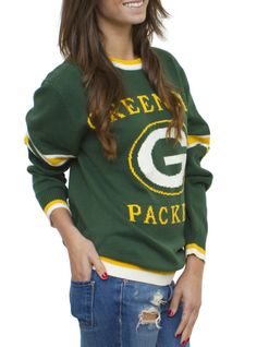 a woman wearing a green bay packers sweater