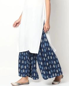 Indigo Handblock Printed Cotton Palazzo Pants | Floral Print Trouser Pants | Large Size Women's Palazzo Embrace the charm of our Cotton Indigo Palazzo pants, featuring intricate handblock printing and a comfortable drawstring waist. These palazzo pants are not only stylish but also designed with consideration for the unique characteristics of traditional techniques. Key Features: Handblock Printing: The characteristic imperfections associated with handblock printing may be observed, adding a dis Summer Cotton Bottoms With Side Slits, Spring Sets With Side Slits, White Rayon Wide-leg Pants, White Wide-leg Rayon Pants, White Cotton Wide Leg Sets, Loosely Fitted Cotton Culottes, White Cotton Long Skirt, Cotton Palazzo Pants, Floral Dress Design