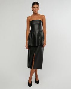 The Black Vegan Leather Midi Made Skirt by We Wore What is a timeless and versatile piece that is perfect for any occasion. It is made from high-quality black leather that is both soft and durable. The skirt features a flattering A-line silhouette and a mid-length cut that is both stylish and comfortable. It is also available in a variety of sizes to fit all body types. <p data-sourcepos="5:1-5:278" data-mce-fragme... Sleek Leather Midi Skirt, Leather Flared Skirt For Night Out, Black Leather Skirt For Evening, Sleek Leather Party Skirt, Elegant Evening Faux Leather Skirt, Leather Skirt For Spring Evenings, Black Leather Knee-length Skirt, Leather Skirt For Evening In Spring, Date Night Fitted Leather Skirt