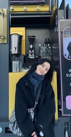 a woman is standing in front of a coffee truck with her hands on her hips