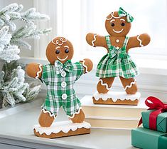 two gingerbread men are standing next to each other