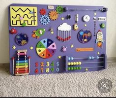 a child's play area with toys and magnets on the wall in front of it