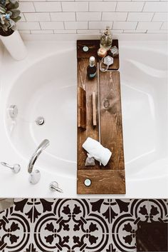 a bathtub with utensils and soap in it