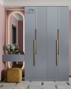 an elegant dressing room with pink walls and gold handles on the doors, along with a stool