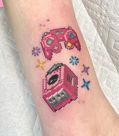 a person with a tattoo on their arm that has an image of a pink car