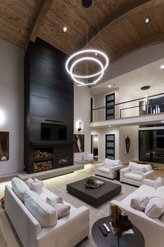 a living room with white couches and a fireplace