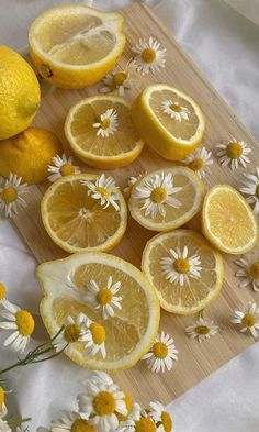 lemons and daisies cut up on a cutting board