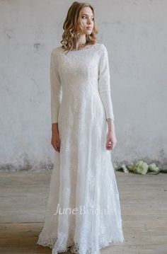 a woman in a white dress standing on a wooden floor