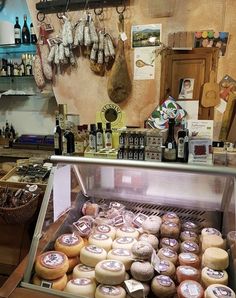 a display case filled with lots of different types of doughnuts on top of a counter