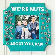 a blue frame with an image of two boys and the words, we're nuts about you, dad