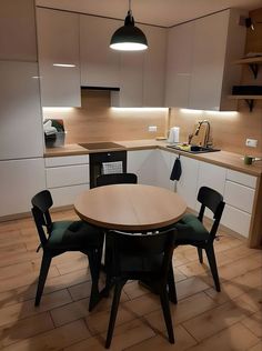 a kitchen with a table and chairs in it