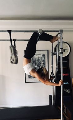 a woman standing on top of a metal bar