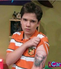 a young boy with tattoos on his arm