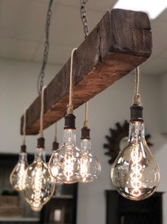 several light bulbs hanging from a wooden beam