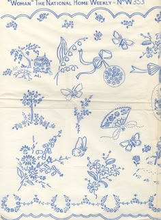 an old blue and white handkerchief with flowers, butterflies, and birds on it's border