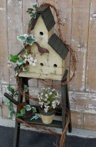 a bird house with plants growing out of it