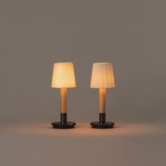 two lamps sitting next to each other on a table